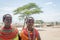 Portrait of two young maasai girls with traditional jewelery and clothing in a native village in Samburu