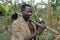 Portrait Ugandan farmer with hoe, portable radio