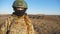 Portrait of ukrainian army woman in helmet and balaclava at countryside. Female military medic looks into camera