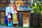 Portrait of ukrainian family dressed in traditional costumes near the house