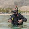 Portrait of underwater diver in basic equipment dives before deep diving. Lessons of underwater diving. Popular water sport and