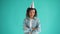 Portrait of unhappy mixed race girl in party hat standing with arms crossed