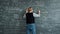 Portrait of unhappy teacher writing on board then leaving when students throwing paper