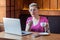 Portrait of unhealthy young bussinesswoman with short blonde hair in pink t-shirt and eyeglasses sitting in cafe working and