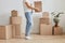 Portrait of unknown anonymous faceless woman wearing jeans moving new place, holding cardboard box with belongings, relocating,