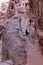 Portrait of unknown bedouin woman on donkey walking a path