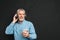 Portrait of unshaved male pensioner 60s with gray hair holding c