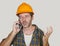 Portrait of upset construction worker or stressed contractor man in builder hat talking on mobile phone unhappy in stress messing