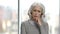 Portrait of upset mature woman on blurred background.