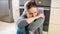 Portrait of upset woman feeling frustrated sitting on kitchen floor