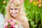 Portrait of a very beautiful bride blonde in a white dress with