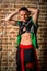 portrait of a very muscular Caucasian male model dancer in national costume against a brick wall