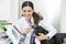 Portrait Of Veterinarian Examining Bulldog With Otoscope