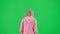 Portrait of victim on chroma key green screen background. Young girl running, scared expression, looking around, running