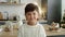 Portrait video of little boy in the kitchen