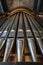 Portrait view of a rank of shining steel pipes of a refurbished church organ