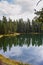 Portrait view of reflections on Trout Lake at Yellowstone National Park