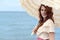 Portrait vintage woman with parasol by ocean