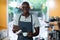 Portrait of waiter making cup of coffee at counter