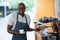 Portrait of waiter using espresso machine