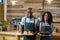 Portrait of waiter and waitress holding a plate of cupcake and croissant