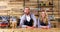 Portrait of waiter and waitresses standing at counter