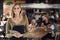 Portrait Of Waitress Holding Menus Serving In Busy Bar Restaurant