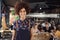 Portrait Of Waitress Serving In Busy Bar Restaurant