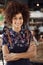 Portrait Of Waitress Serving In Busy Bar Restaurant