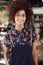 Portrait Of Waitress Serving In Busy Bar Restaurant