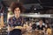 Portrait Of Waitress Serving Food To Customers In Busy Bar Restaurant