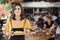 Portrait Of Waitress Serving Food To Customers In Busy Bar Restaurant