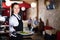 Portrait of waitress with serving tray meeting restaurant guests