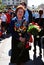 Portrait of a war veteran woman smiling holding flowers buds.