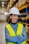 Portrait of warehouse female worker in reflective vest.