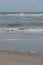 Portrait of waves breaking onto a sandy beach