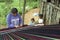 Portrait of weaving Indian woman with children