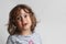 Portrait on white background of a 3-4 year old girl playing and laughing