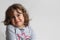 Portrait on white background of a 3-4 year old girl playing and laughing