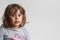 Portrait on white background of a 3-4 year old girl playing and laughing