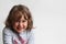 Portrait on white background of a 3-4 year old girl playing and laughing