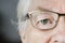 Portrait of white elderly woman closeup on eyes wearing specatacles