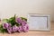 Portrait white picture frame mockup on wooden table. Modern vase with tulips.Scandinavian interior