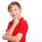 Portrait of white smiling kid in a red t-shirt looking away.  Photo of a thinking  boy looking away.  Caucasian boy with a sly