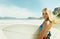 Portrait, wind and woman on beach with surfboard in summer for sports, travel or vacation on coast. Face, fitness and