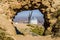 Portrait Of A Windmill Through A Hole In The Mountain On Cerro Calderico In Consuegra. December 26, 2018. Consuegra Toledo