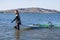 Portrait of windsurfer with windsurfing equipment in shallow water