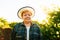 portrait of winemaker woman with hat looking at camera at sunset.