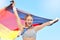 Portrait of winning athlete cheering, holding German flag after competing in sports. Smiling fit active sporty motivated