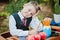 Portrait of a wistful first-grader boy sitting at a desk